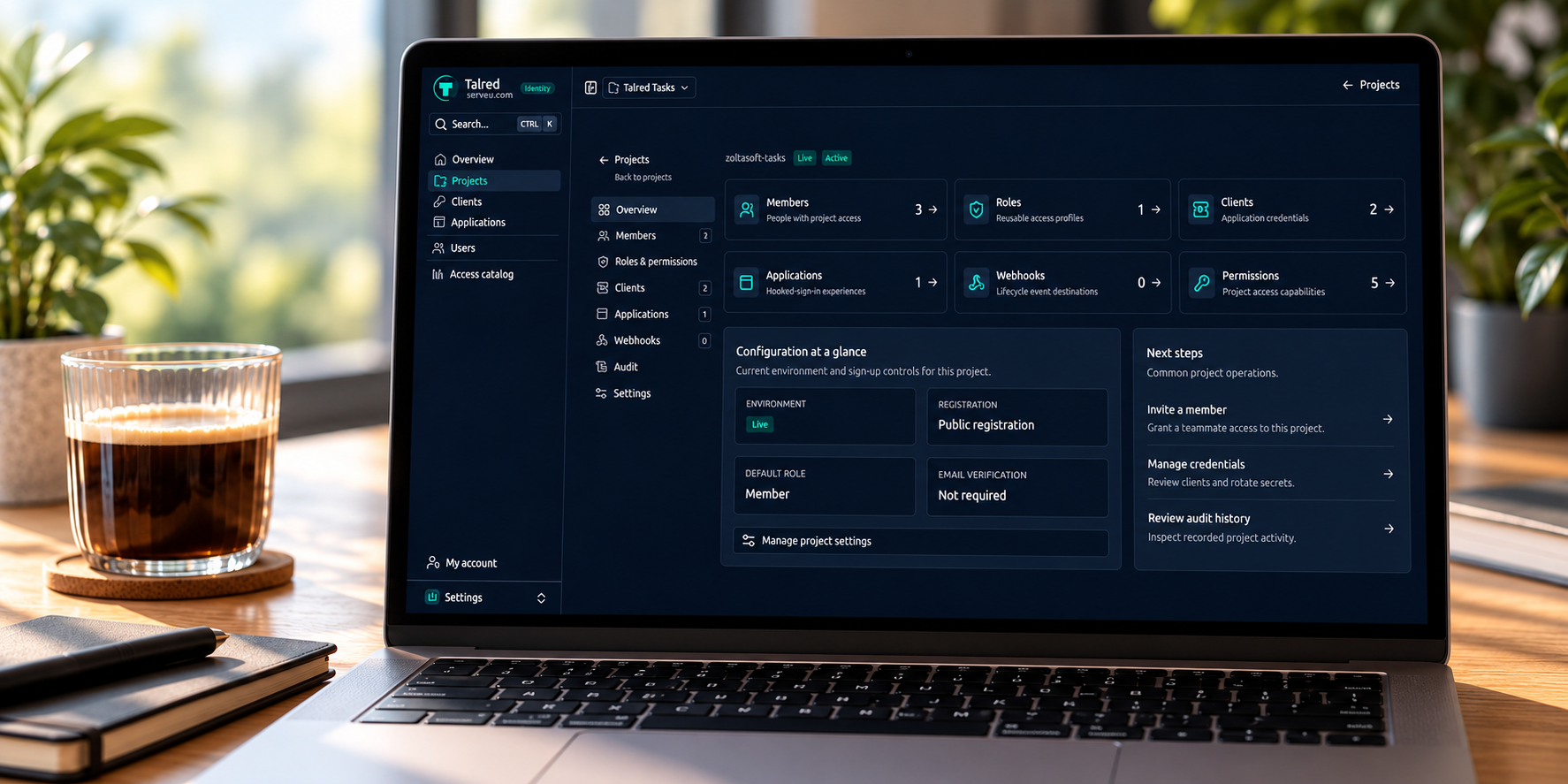 Talred Identity project dashboard displayed on a laptop at a desk.
